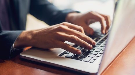 Person typing on computer.