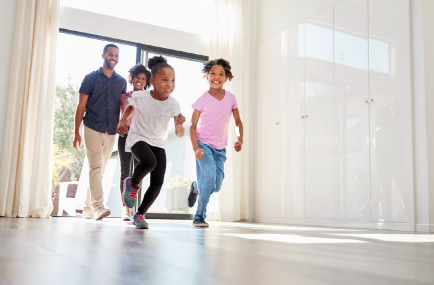 family walking into new house